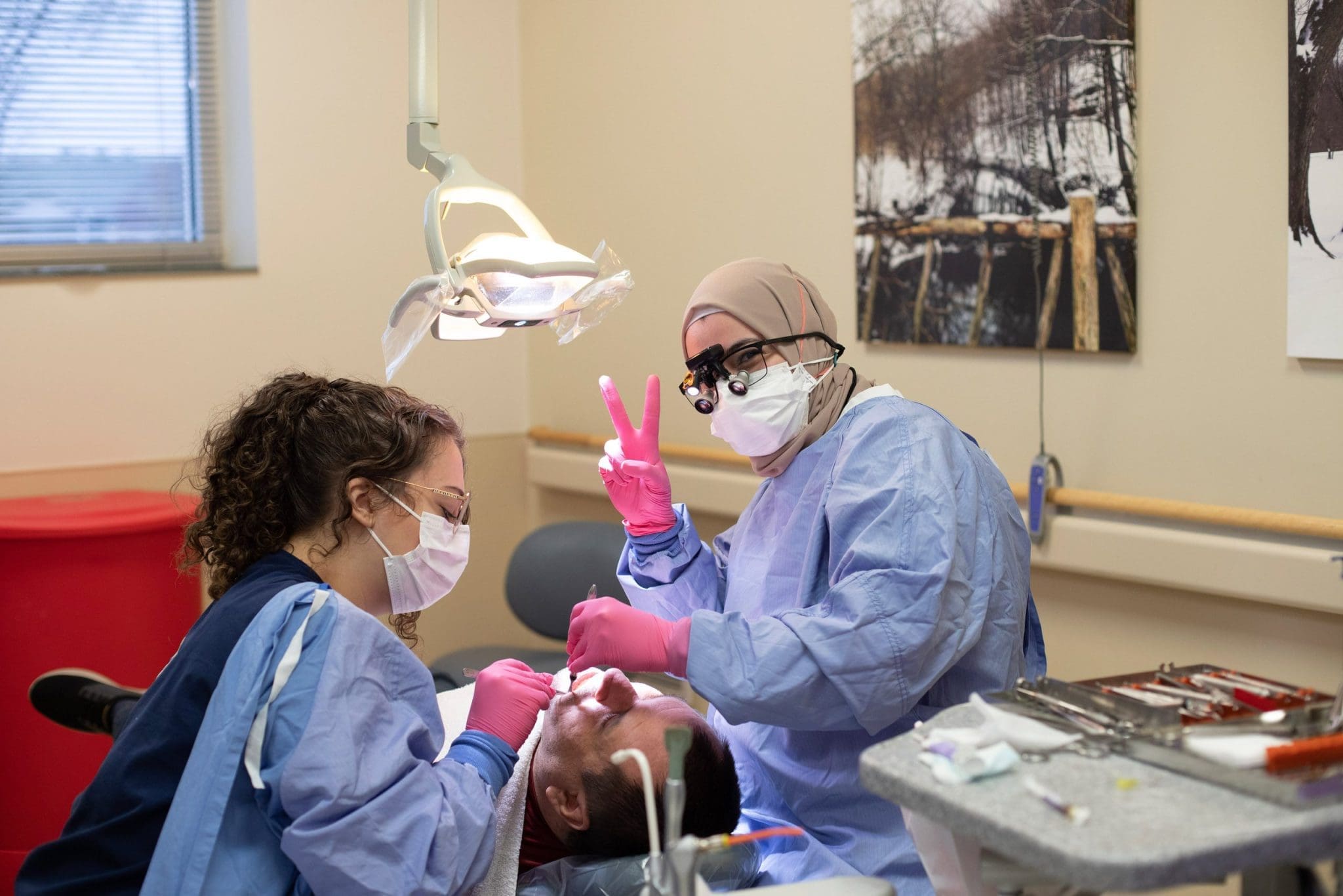 Dentist and dental students provide sensory-friendly care while treating an autistic patient during a specialized dental appointment.
