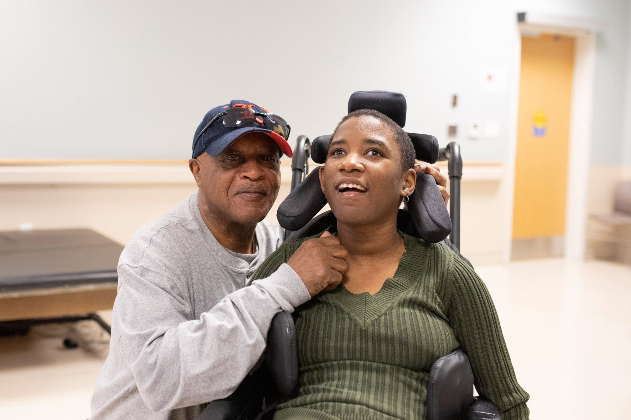 Caregiver supporting a person in a wheelchair at Lee Specialty Clinic