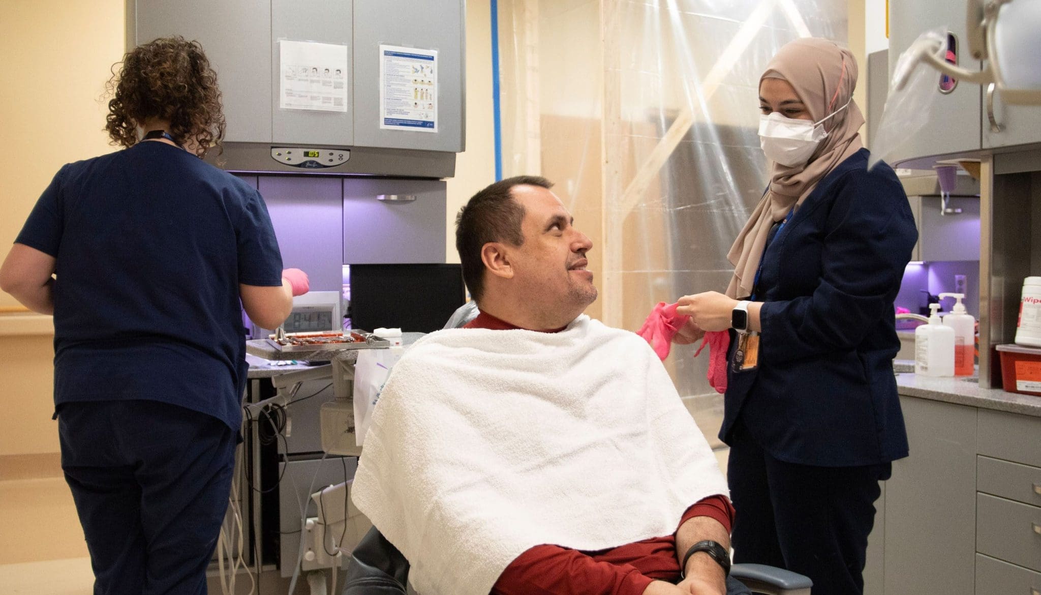 A man on the autism spectrum smiles as he receives specialized dental care from a sensory-friendly dentist, ensuring a comfortable and supportive experience.