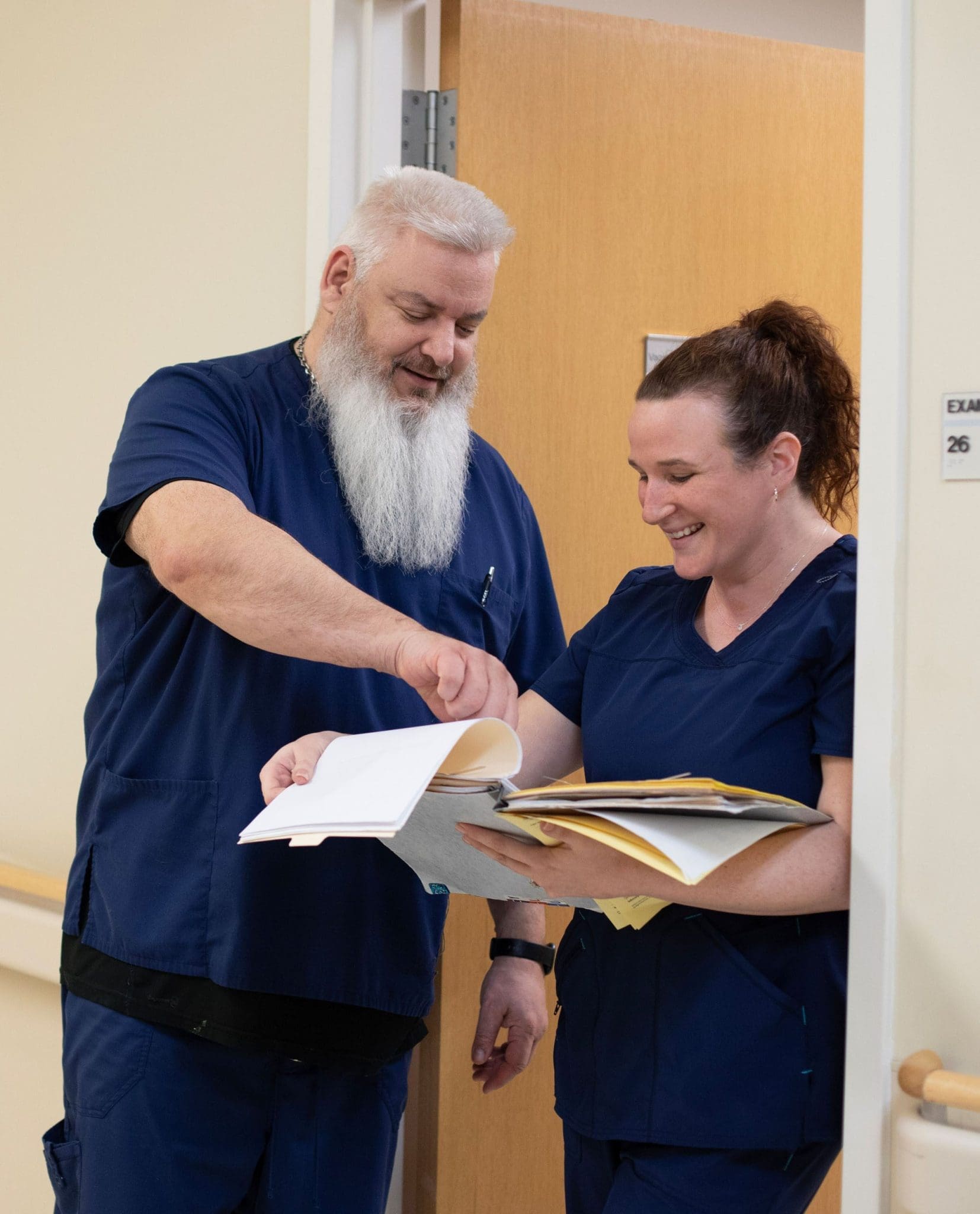 Healthcare providers reviewing patient care reports to improve treatment planning for individuals with intellectual and developmental disabilities (IDD).