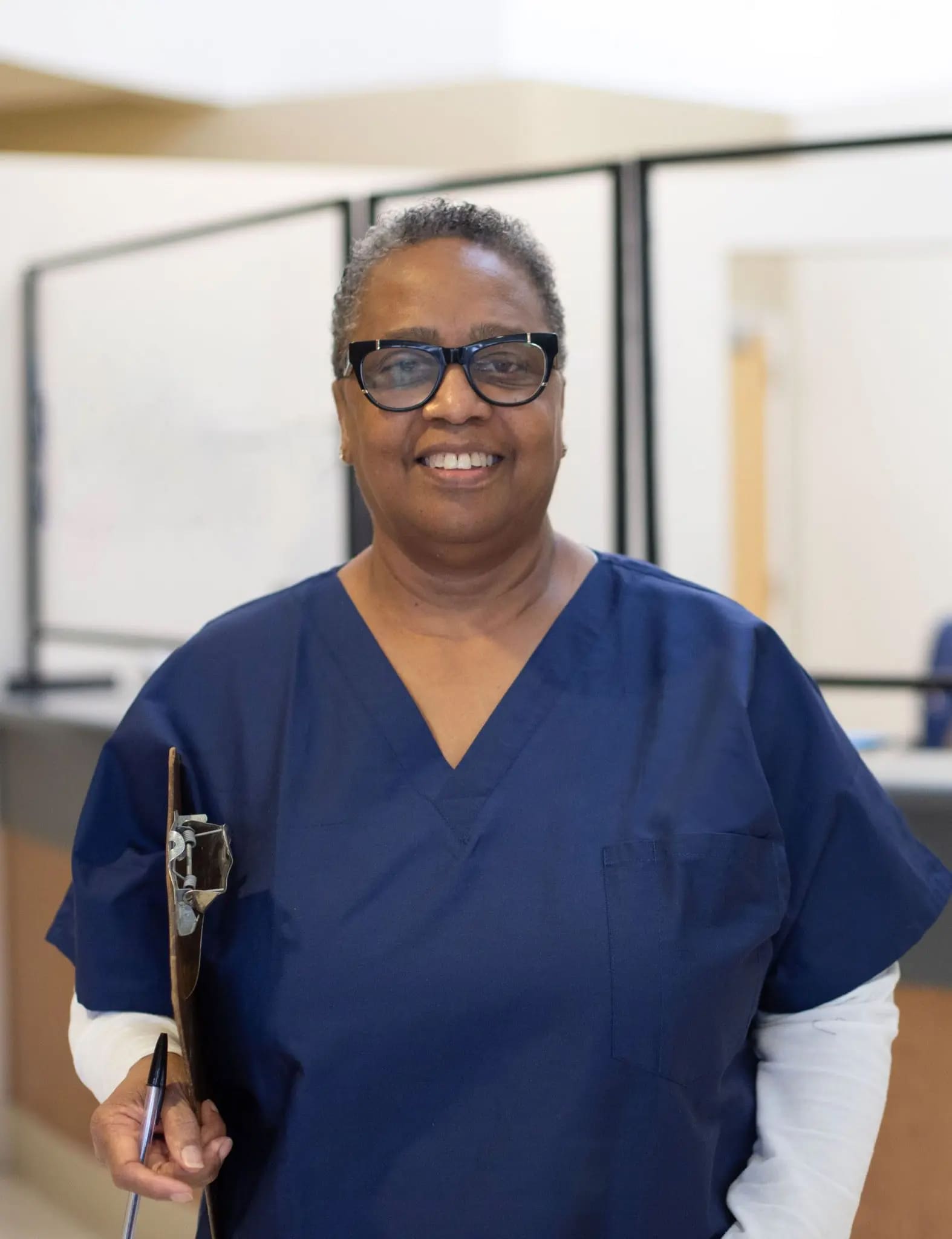 Smiling receptionist ready to greet patients and caregivers at Lee Specialty Clinic, a leading provider of integrated healthcare for neurodivergent individuals, including those with Global Developmental Delay (GDD), Autism Spectrum Disorder (ASD), Cerebral Palsy (CP) and more.