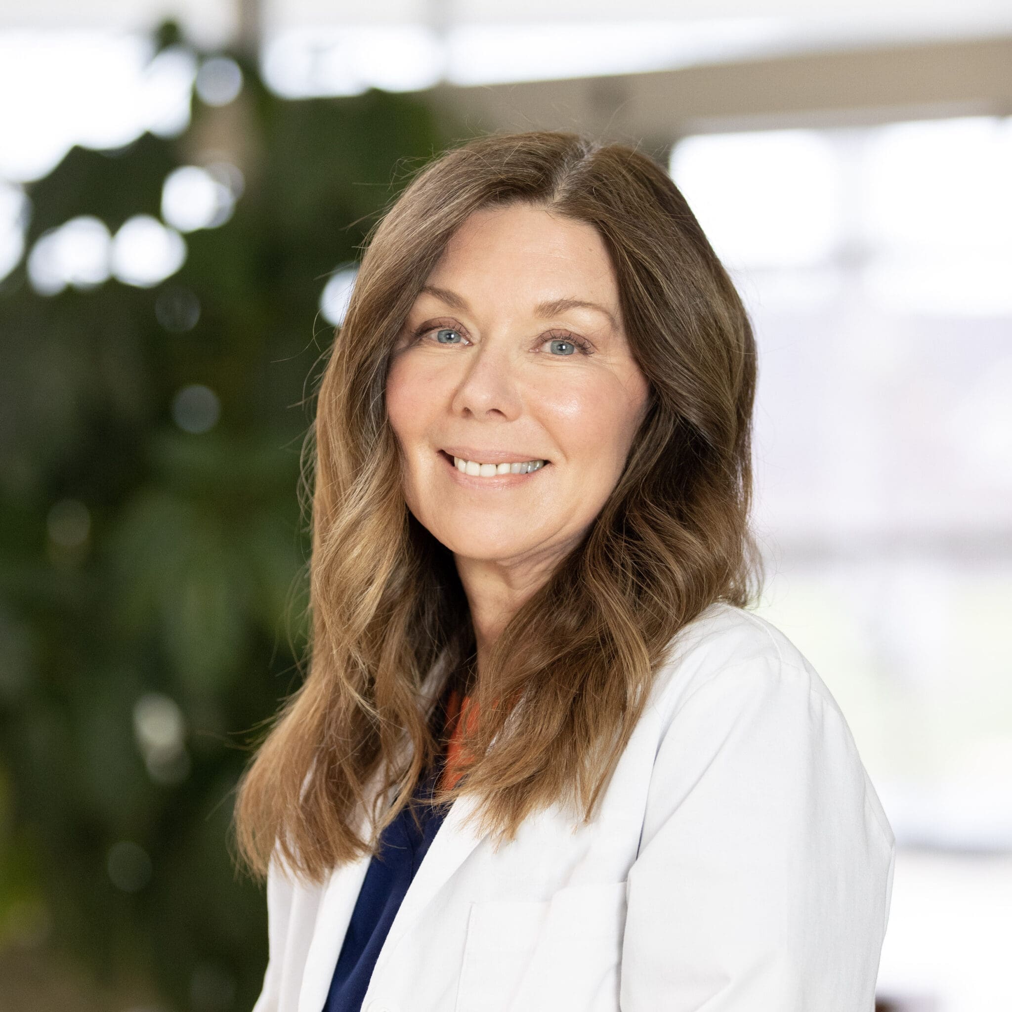 Lee Specialty Clinic staff member smiling in a white coat