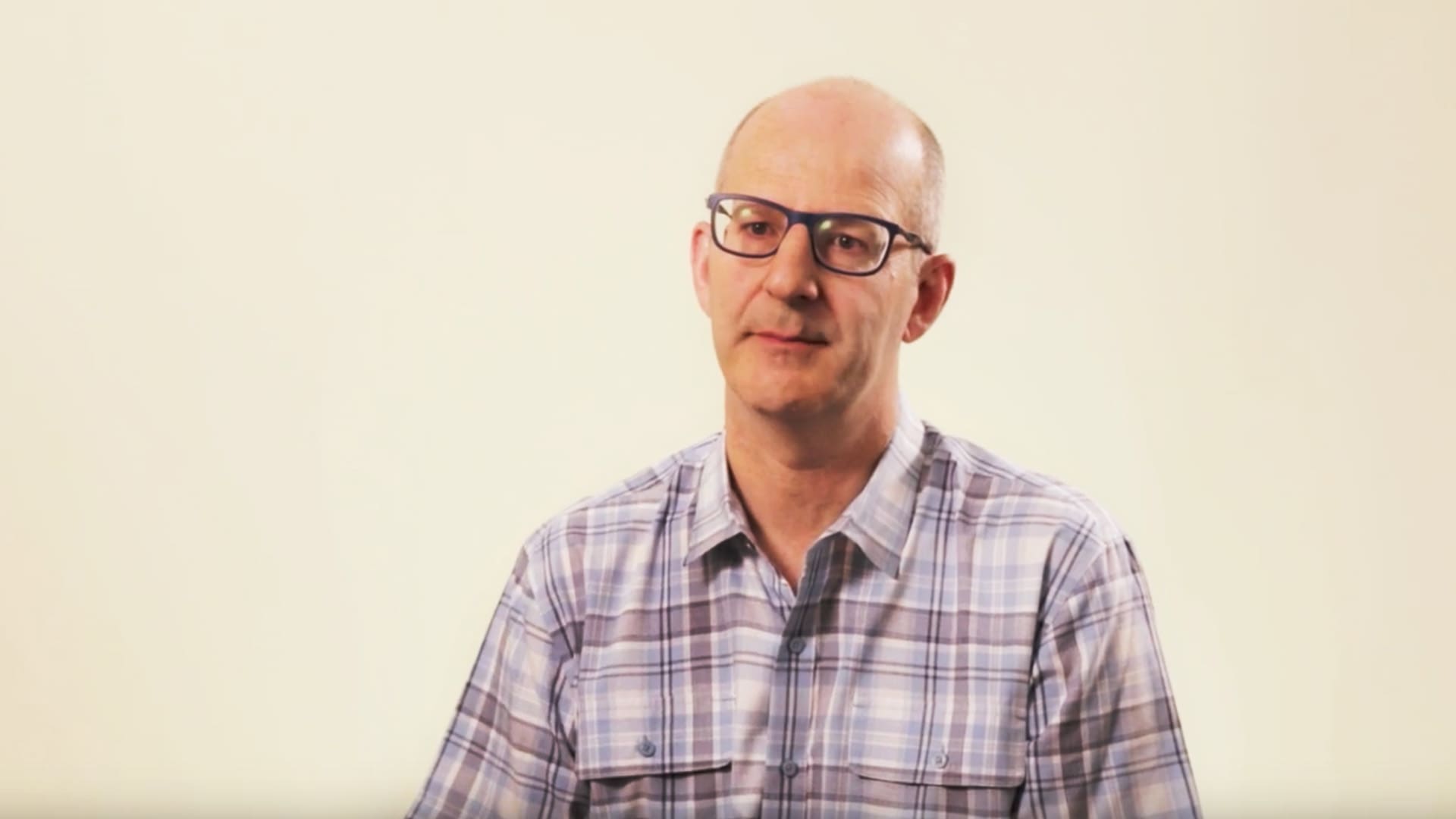 Lee Specialty Clinic staff member wearing glasses and a plaid shirt
